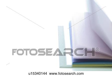 Picture - Notebook with colorful pages lying open on desk. Fotosearch