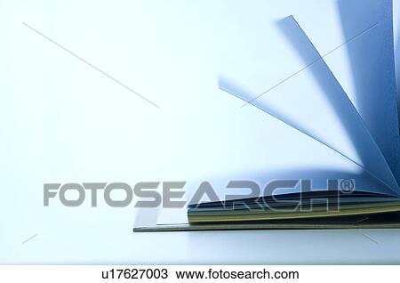 Stock Image - Notebook with colorful pages lying open on desk. Fotosearch
