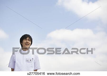 Stock Photograph - Nurse standing outside. Fotosearch