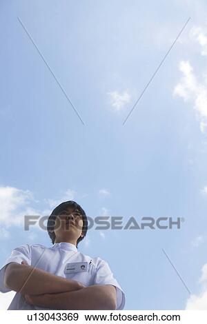 Nurse standing outside with folded arms View Large Photo Image Stock Photo - Nurse standing outside with folded arms. Fotosearch