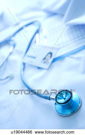 Stock Photograph - Nurse uniform, name tag, document and a stethoscope. Fotosearch