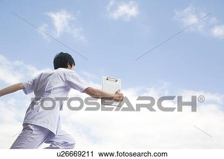 Nurse walking and holding chart View Large Photo Image Stock Image - Nurse walking and holding chart. Fotosearch
