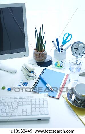 Stock Photo - Office supplies and coffee on desk with computer. Fotosearch