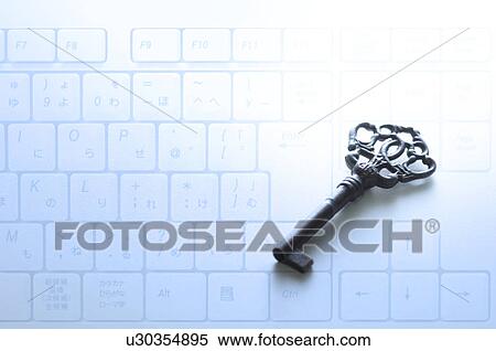 Stock Photography - Old-fashioned key against computer keyboard. Fotosearch