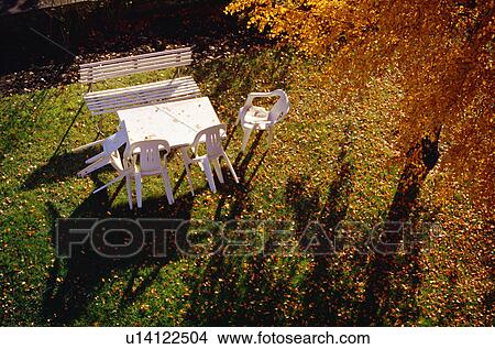 Picture - Outdoor table with autumn leaves. Fotosearch