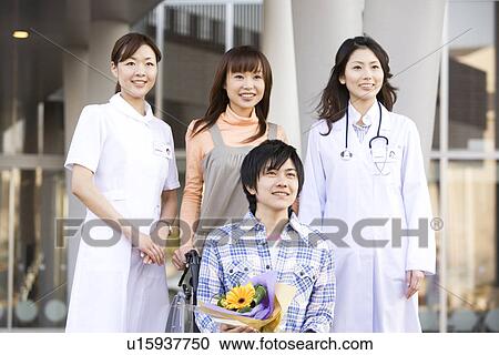 Patient with his doctor and nurse outside a hospital View Large Photo Image Stock Image - Patient with his doctor and nurse outside a hospital. Fotosearch