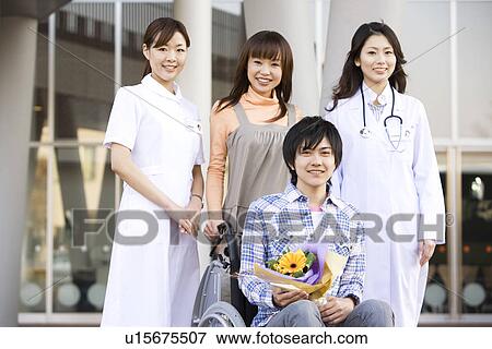 Patient with his doctor and nurse outside a hospital View Large Photo Image Stock Photo - Patient with his doctor and nurse outside a hospital. Fotosearch