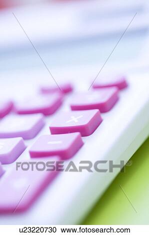 Stock Image - Pink calculator on desk. Fotosearch