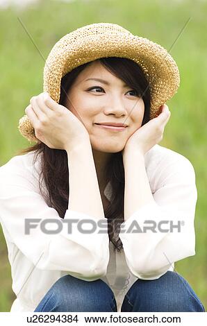Portrait of woman wearing straw hat View Large Photo Image Picture - Portrait of woman wearing straw hat. Fotosearch