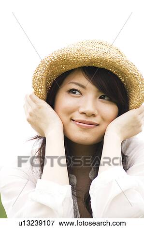 Portrait of woman wearing straw hat View Large Photo Image Stock Photo - Portrait of woman wearing straw hat. Fotosearch