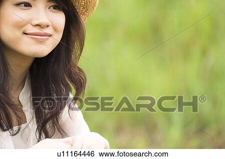 Portrait of woman wearing straw hat View Large Photo Image Stock Photograph - Portrait of woman wearing straw hat. Fotosearch