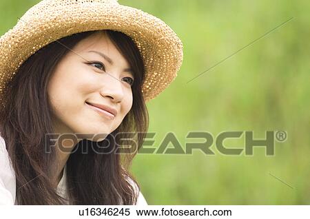 Portrait of woman wearing straw hat View Large Photo Image Stock Photography - Portrait of woman wearing straw hat. Fotosearch