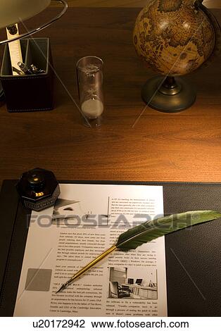Stock Image - Quill pen and document on desk. Fotosearch