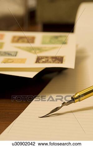 Quill pen on blank note pad View Large Photo Image Stock Image - Quill pen on blank note pad. Fotosearch