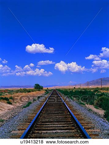 Stock Photo - Railroad tracks through landscape. Fotosearch
