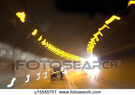 Stock Image - Road traffic in tunnel. Fotosearch