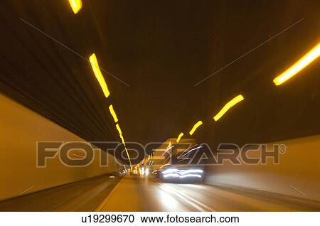Stock Image - Road traffic in tunnel. Fotosearch