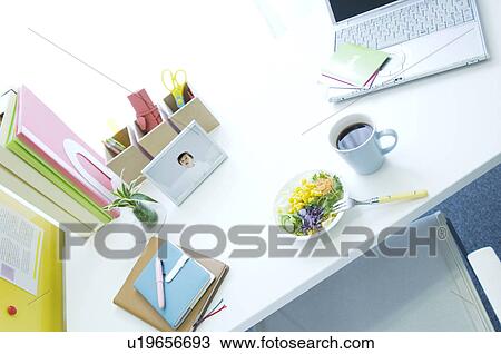 Stock Image - Salad, coffee cup and laptop on desk. Fotosearch