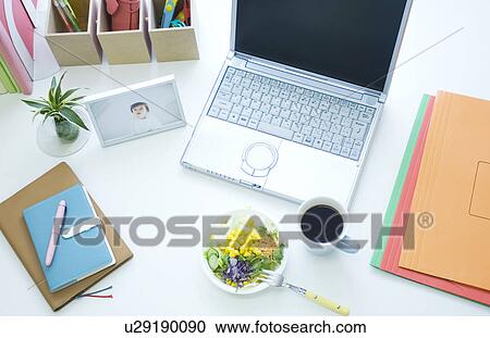 Stock Image - Salad, coffee cup and laptop on desk. Fotosearch
