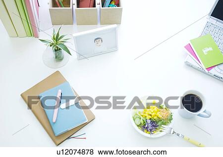 Stock Photo - Salad, coffee cup and laptop on desk. Fotosearch