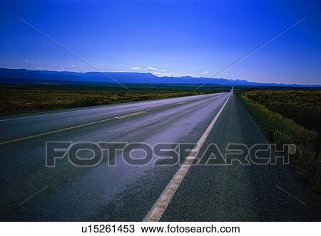 Straight road through landscape View Large Photo Image Stock Image - Straight road through landscape. Fotosearch