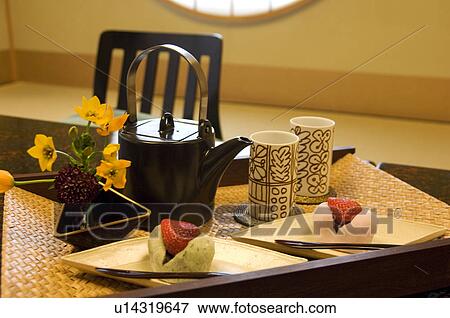 Stock Photo - Teapot and rice cakes on table. Fotosearch