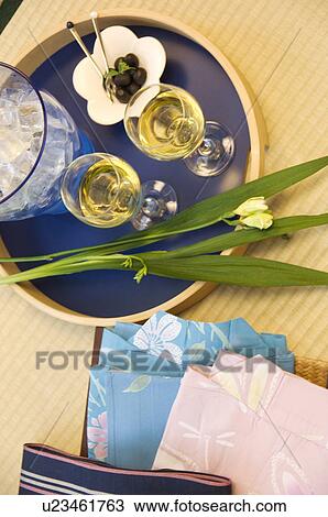 Tray with wine glasses and finger food next to pile of folded yukata View Large Photo Image Stock Image - Tray with wine glasses and finger food next to pile of folded yukata. Fotosearch