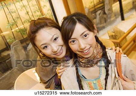 Stock Photography - Two friends in a hotel lobby. Fotosearch