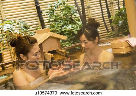 Stock Photo - Two women relaxing in a hot tub. Fotosearch
