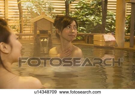 Stock Photo - Two women relaxing in a hot tub. Fotosearch