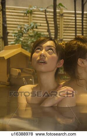 Stock Photo - Two women relaxing in a hot tub. Fotosearch