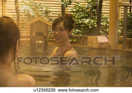 Two women relaxing in a hot tub View Large Photo Image Stock Photograph - Two women relaxing in a hot tub. Fotosearch
