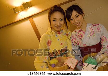 Two women wearing yukata and holding spa products at a health spa View Large Photo Image Stock Photography - Two women wearing yukata and holding spa products at a health spa. Fotosearch