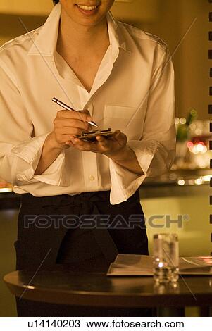 Waiter taking a customer's order View Large Photo Image Stock Image - Waiter taking a customer's order. Fotosearch