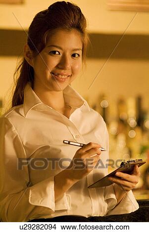 Picture - Waitress taking a customer's order. Fotosearch