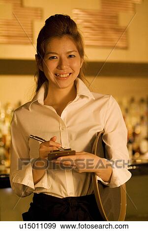 Waitress taking a customer's order View Large Photo Image Stock Photo - Waitress taking a customer's order. Fotosearch