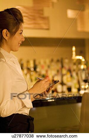 Stock Photo - Waitress taking a customer's order. Fotosearch
