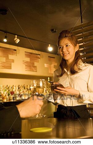 Waitress taking a customer's order View Large Photo Image Stock Photograph - Waitress taking a customer's order. Fotosearch