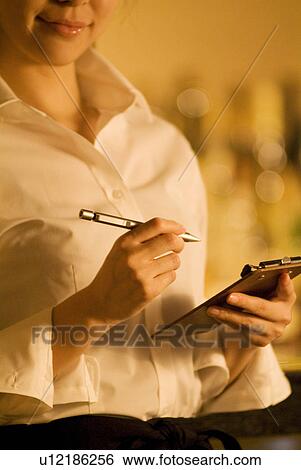Waitress taking a customer's order View Large Photo Image Stock Photograph - Waitress taking a customer's order. Fotosearch