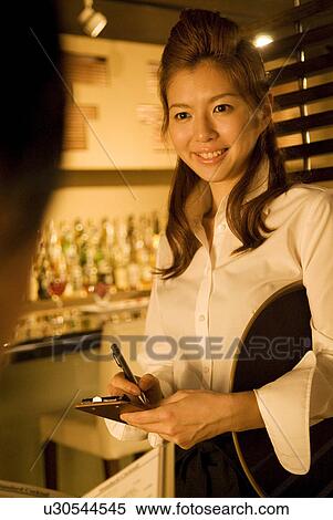 Stock Photography - Waitress taking a customer's order. Fotosearch