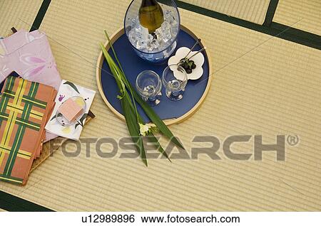 Wine bottle on ice on tray next to glasses and folded yukata View Large Photo Image Stock Photograph - Wine bottle on ice on tray next to glasses and folded yukata. Fotosearch