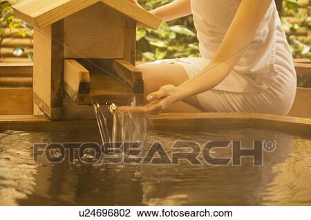 Woman checking the temperature of a hot tub View Large Photo Image Stock Image - Woman checking the temperature of a hot tub. Fotosearch