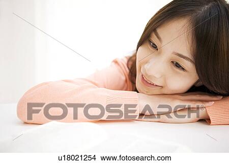 Woman daydreaming at her desk View Large Photo Image Picture - Woman daydreaming at her desk. Fotosearch