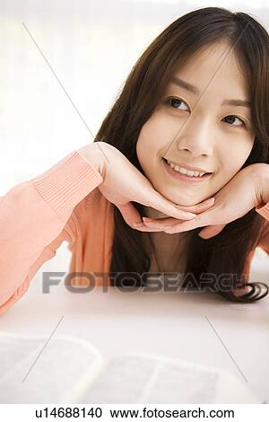 Woman daydreaming at her desk View Large Photo Image Stock Image - Woman daydreaming at her desk. Fotosearch