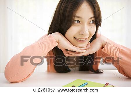 Woman daydreaming at her desk View Large Photo Image Stock Photo - Woman daydreaming at her desk. Fotosearch