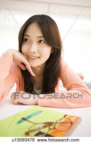 Woman daydreaming at her desk View Large Photo Image Stock Photo - Woman daydreaming at her desk. Fotosearch
