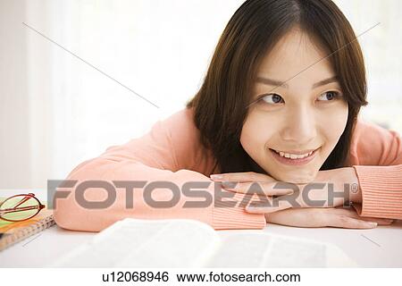 Woman daydreaming at her desk View Large Photo Image Stock Photograph - Woman daydreaming at her desk. Fotosearch