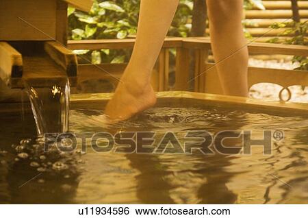 Woman dipping her toes into a hot tub View Large Photo Image Stock Photograph - Woman dipping her toes into a hot tub. Fotosearch