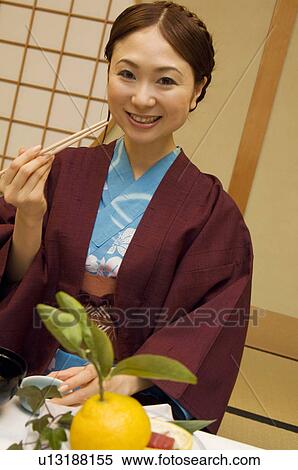 Woman dressed in a yukata smiling at the camera View Large Photo Image Stock Photography - Woman dressed in a yukata smiling at the camera. Fotosearch