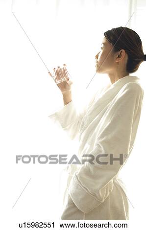 Woman drinking water from a bottle View Large Photo Image Stock Image - Woman drinking water from a bottle. Fotosearch